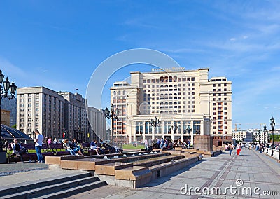 People having a rest on benches on Manezh Square in Moscow