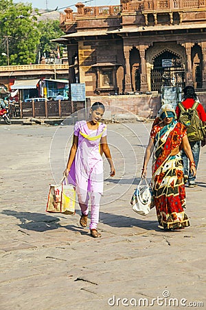 People hurry at the Sadar market at