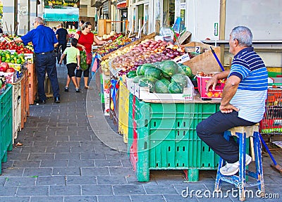 People on an Israel outdoor fruit and vegetable market