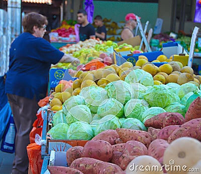 People on an Isral outdoor fruit and vegetable market