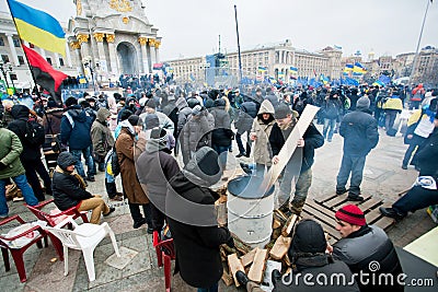 People kindle fire on the cold occupying Maidan square during two weeks anti-government protest