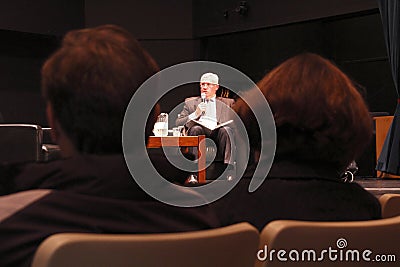 People listens to a local mayoralty debate