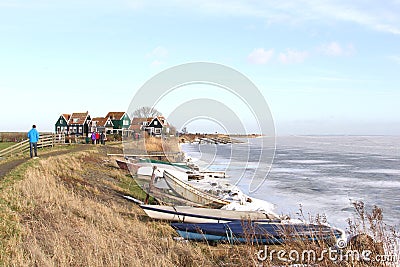 People near the village Marken along a frozen Markermeer in the Netherlands