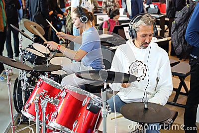 People play on the electronic drum kit