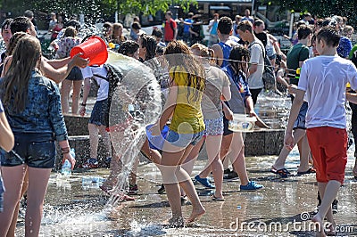 People pour water on each other