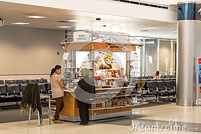 People at a retail kiosk in airport