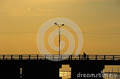 People ride bicycle on the bridge