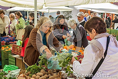 People selling and buying in a traditional farmers market in Portugal, Europe