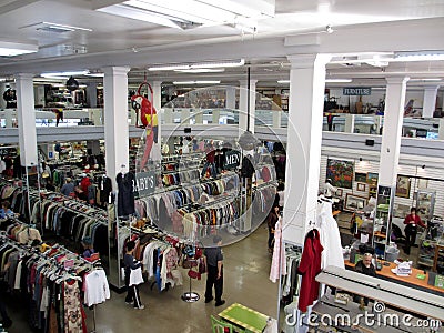 People shop for clothes inside a thrift store