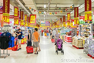 People Shopping In Supermarket Store Aisle