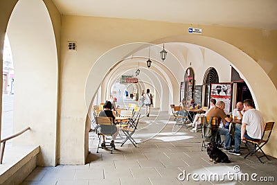 People sitting outdoor around the tables of bar