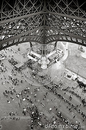 People standing in line under the Eiffel Tower in Paris