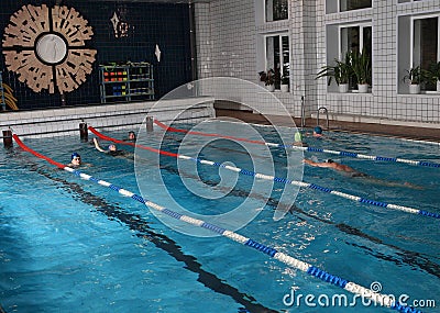 People swim in the indoor public pool.