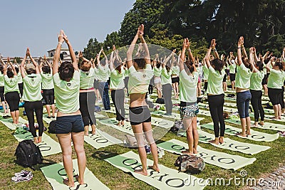 Almost 2000 people take a free collective yoga class in a city park in Milan, Italy