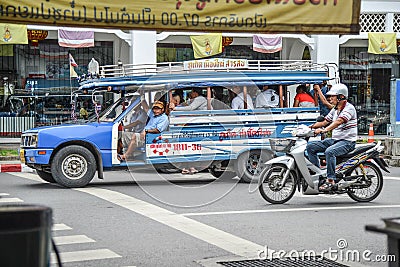 People travel by local minibus in Phuket.