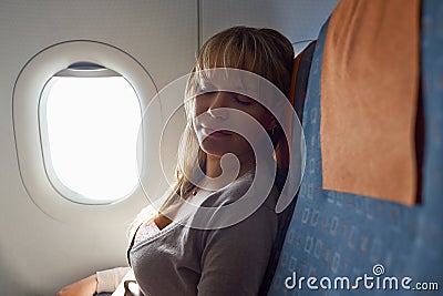 People travelling relaxed woman sleeping on plane