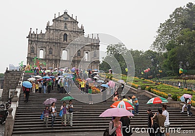 People under umbrellas. Church of St Paul. Macau.