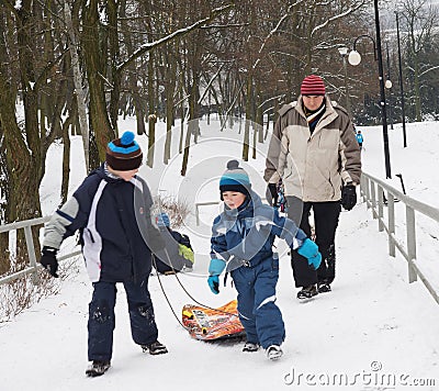 People using a sled in the winter