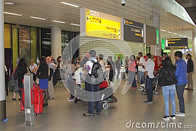 People are waiting in the arrival hall at Schiphol airport