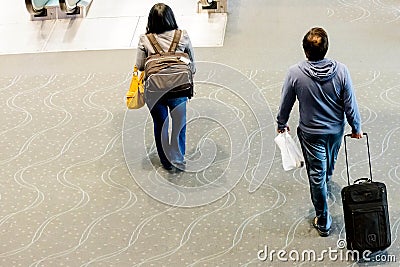 People walking with luggage in airport