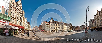 People walking on Main Market Square in Wroclaw.