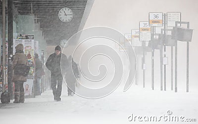People walks under unexpected heavy snow