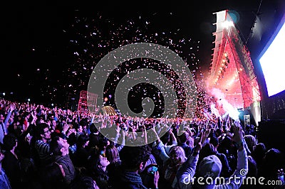 People watching a concert, while throwing confetti from the stage at Heineken Primavera Sound 2013 Festival