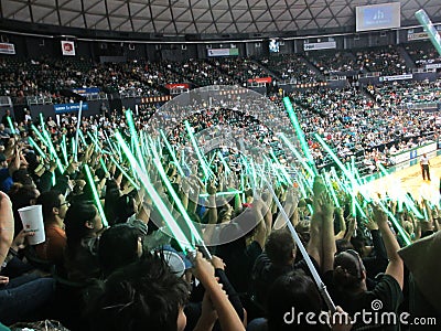 People wave light sabers in the air to distract free throw shoot