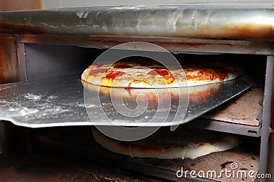 Pepperoni Pizza coming out of oven