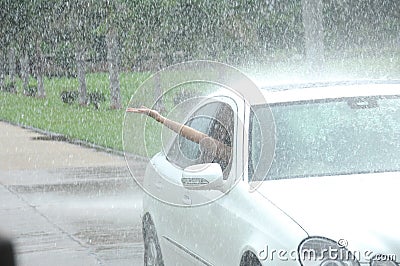 Person driving car in rain
