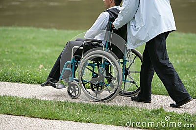 Person pushing a disabled person