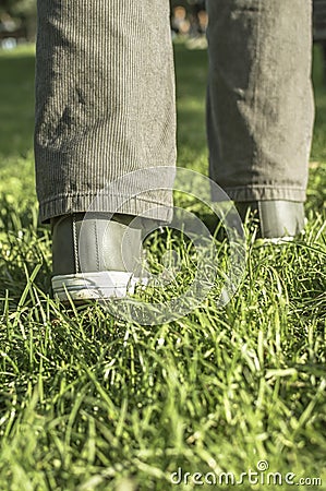 Person walking on green grass