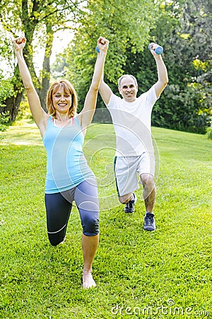 Personal trainer with client exercising outdoors