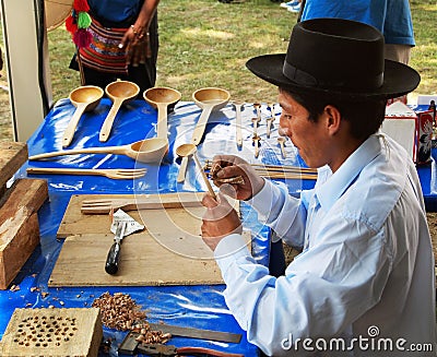 JULY 1: A Peruvian man finishes wooden kitchen utensils with carving ...