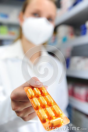 Pharmacist with mask selling medicine