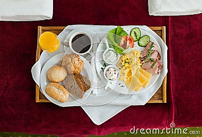 Photo of tray with breakfast food on the bed