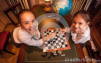 Photo of two girls playing chess