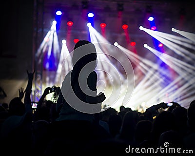 Photo of young people having fun at rock concert, active lifestyle,