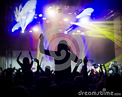 Photo of young people having fun at rock concert, active lifestyle,