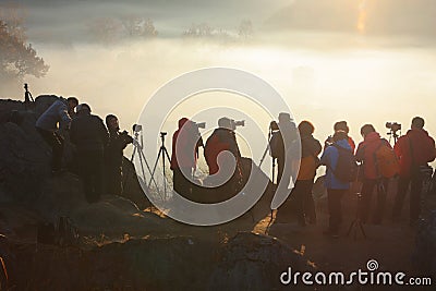 Photographers waits sunrise on mountain