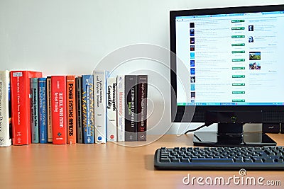 Physics books near desktop computer