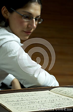 Piano Teacher Reading Music