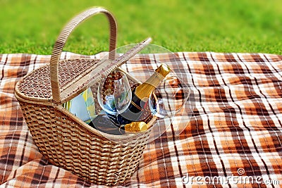 Picnic blanket and basket in the grass