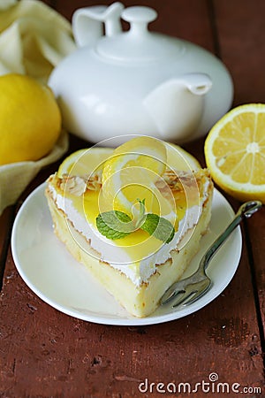 Piece of lemon cake tart decorated with fresh lemon