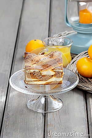 Piece of toffee and vanilla cake on transparent glass cake stand