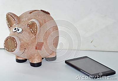 Pig piggy-bank and smartphone