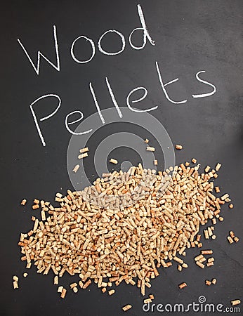 Pile of wood pellets on a blackboard with the words wood pellet