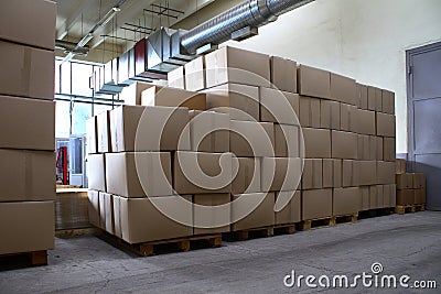 Piles of paper boxes with goods in storage