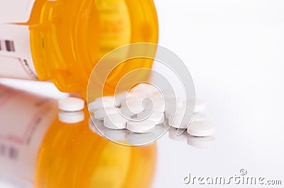 Pills pouring from bottle