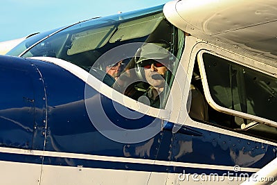 Pilot and co-pilot in cockpit of Cessna 180